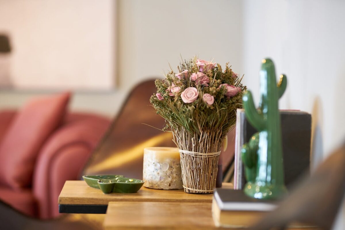 Services Elegant floral arrangement on a wooden table in a modern cozy interior setting.